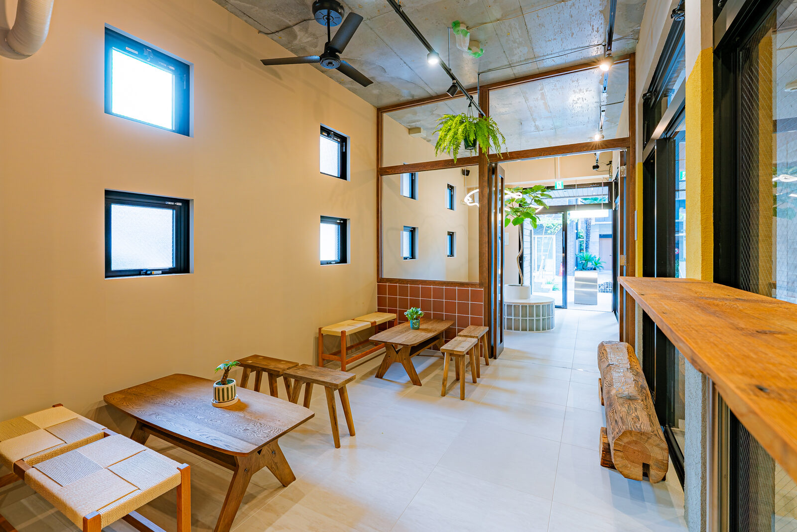 Waiting area with reclaimed-wood benches and single-slab fixtures